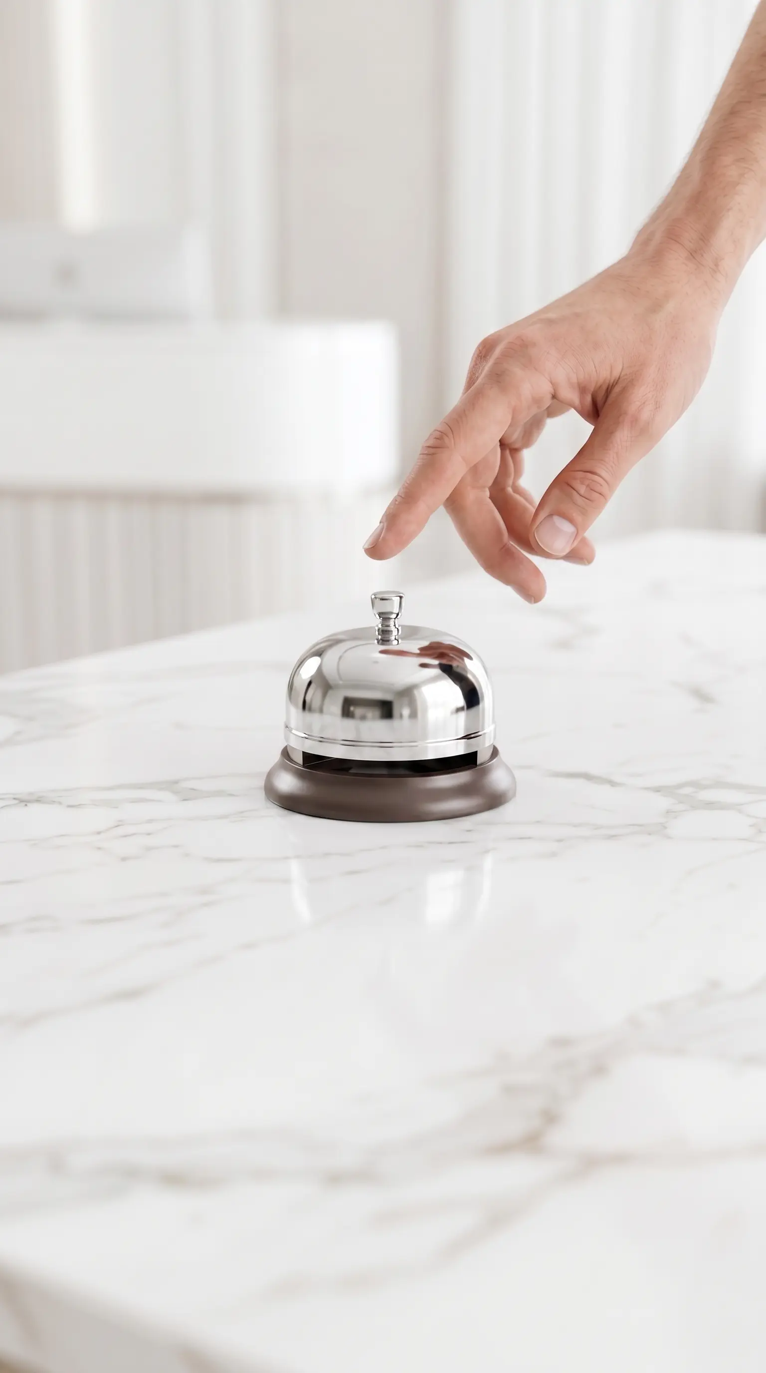 Ringing a service bell on a marble desk